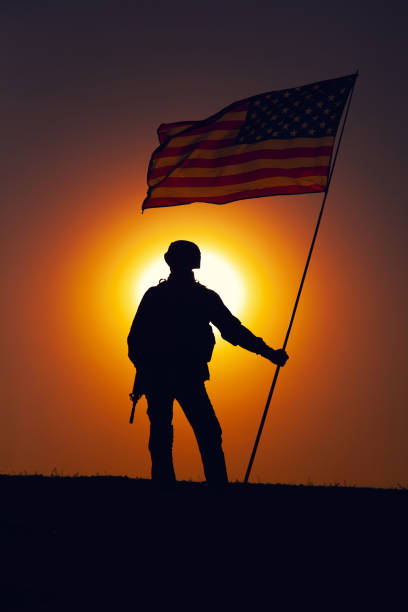 istock USA army soldier with flag on sunset background 1288268979