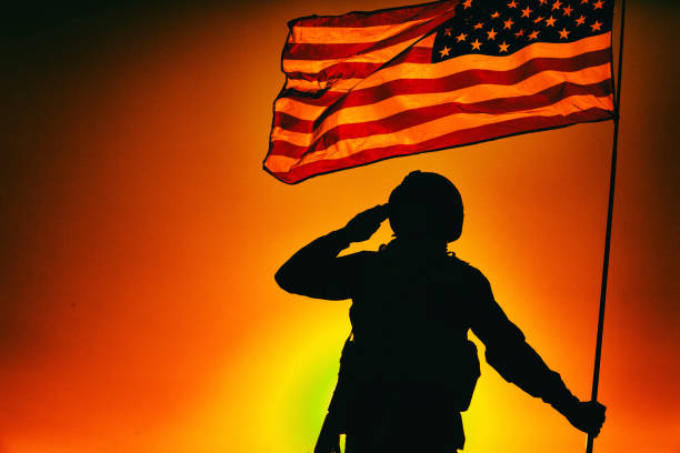 istock US soldier saluting and honoring fallen heroes 1288269017