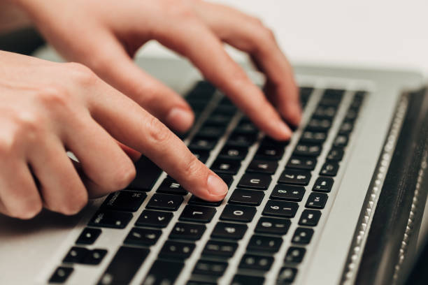 istock Close-Up Shot of Human Hands Placed Over Laptop 1288270218