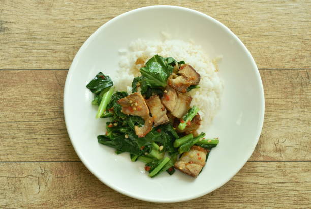 istock stir fried Chinese kale with crispy pork and rice 1288270302