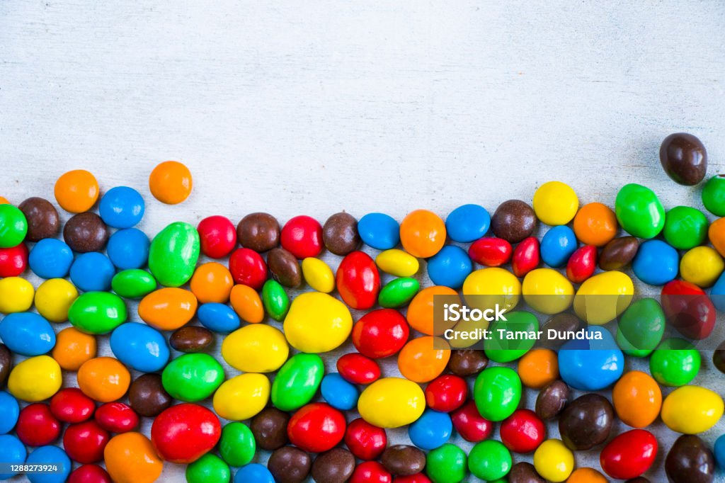 Colorful candies background M&M's candy on the white background, colorful candy texture, multicolored gradient. Candy Stock Photo