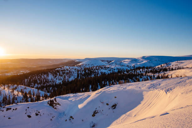 istock Sunset over snowy mountain landscape 1288275052