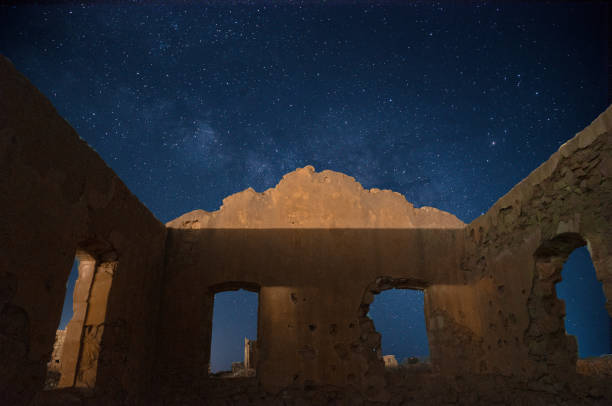 istock Old village ruins under Milky Way 1288276080