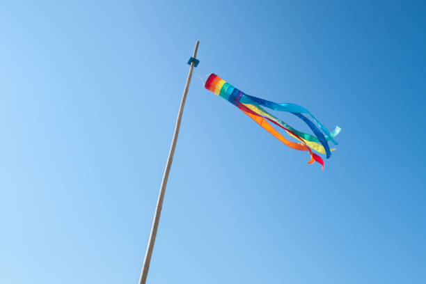 Rainbow wind sock fluttering in the wind stock photo