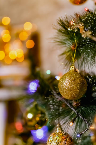 istock Golden Christmas decorations on a green artificial Christmas tree. Making a festive Christmas. Funny cute toys and gifts 1288276706