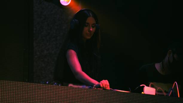 istock DJ on stage in disco night club mixing techno music beat 1288278892