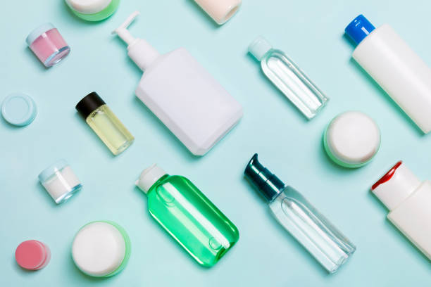istock Top view of different cosmetic bottles and container for cosmetics on blue background. Flat lay composition with copy space 1288278992