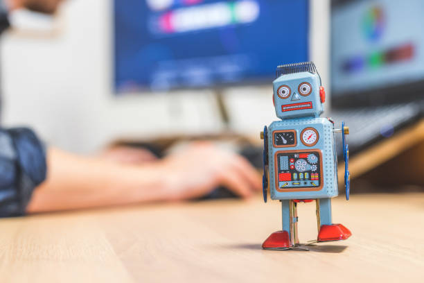 istock Artificial intelligence concept: Toy robot on office desktop. Metaphor for chatbot, social bot and algorithms 1288279853
