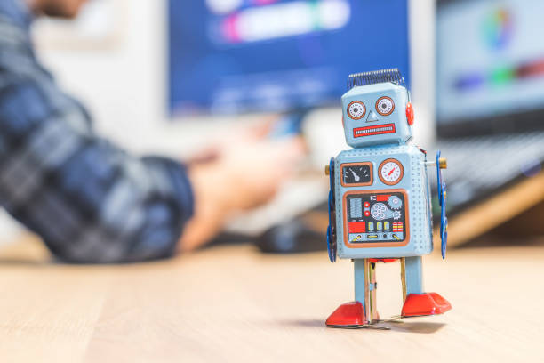 istock Artificial intelligence concept: Toy robot on office desktop. Metaphor for chatbot, social bot and algorithms 1288279878
