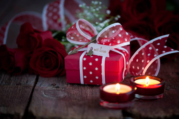 istock Valentine's Day Gift with Red Roses on a Dark Wood Background 1288281445