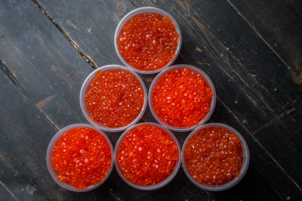 istock Pink salmon caviar and chum salmon caviar in plastic containers 1288288056