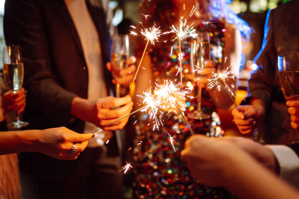 istock Sparkling sparklers in the hand. Celebration, people and holidays concept. 1288290413