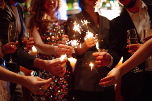 istock Sparkling sparklers in the hand. Celebration, people and holidays concept. 1288290420