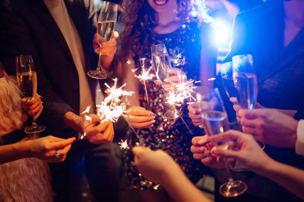 istock Sparkling sparklers in the hand. Celebration, people and holidays concept. 1288290436