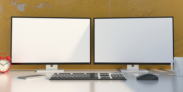 Two blank white computer screens on desktop monitors, keyboard, mouse and smartphone on office desk. Business office workplace, copy space, template. 3d illustration