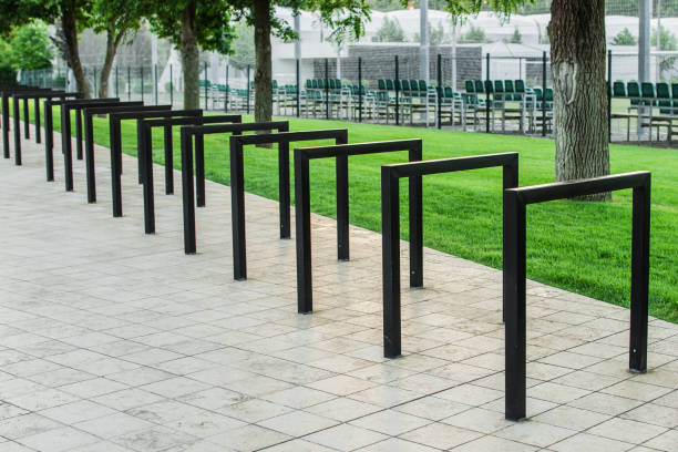 istock Empty bicycle parking racks in park. Metal construction for Parking of bicycles, scooters, environmental transport in the city. Eco-friendly and sports transport in the city. 1288292221