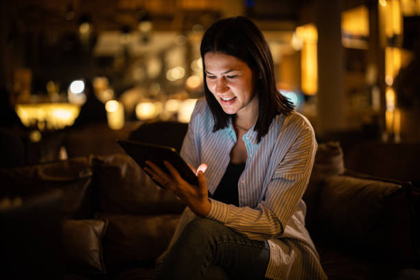 istock Smiling well dressed woman sitting in cafe and using tablet 1288292881
