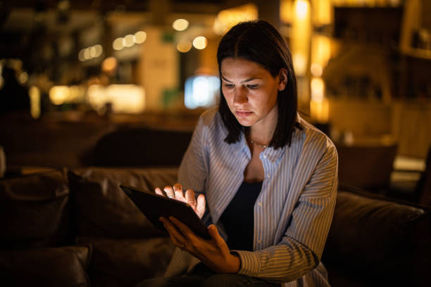 istock Woman sitting in cafe and typing on tablet 1288292897