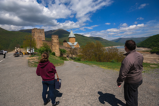 Georgia, Ananuri -May 7, 2015: Travelers enjoy the view of Ananuri Monastery.