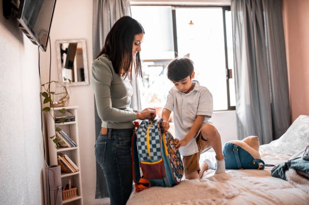istock Young boy zipping his backpack 1288296296