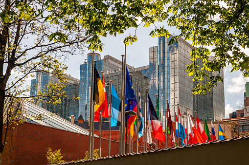 New York City, NY, USA - September 1, 2015: UN United Nations general assembly building on a bright sunny day with blue sky, with world flags flying in front.