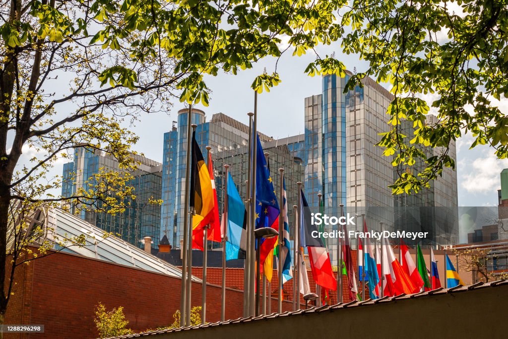 As seen from the Leopold park, a row of flags from Europeam member states with European Parliament in Brussels in the background In front of the the Paul Henri Spaak building of the European Parliament in Brussels, a row of flags of member states of the European Union.. As seen from the Brussels Leopold Park with view on the European Parliament. The Parliament's committee meetings are held primarily here in Brussels. The Paul-Henri Spaak building of the European Parliament was named after former President Paul-Henri Spaak. It houses the plenary sessions as well as a press centre and offices for the Parliament's president. It has a striking cylinder-shaped glass dome. City of Brussels Stock Photo