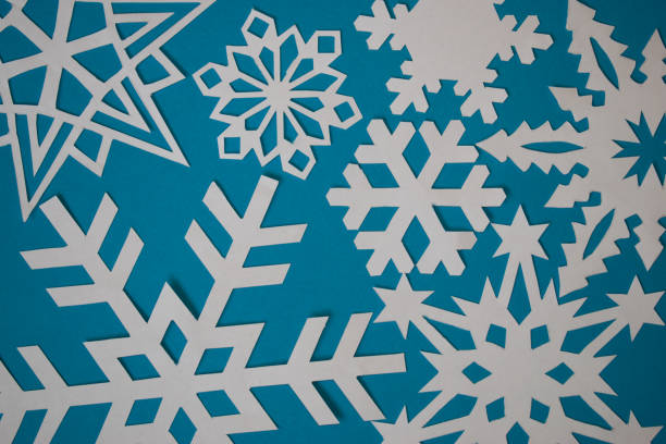 istock Various paper handmade snowflakes on light blue background 1288296305