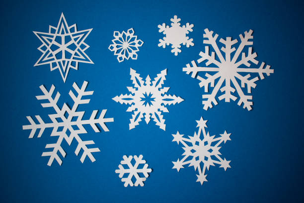 istock Various paper snowflakes on blue background 1288296313