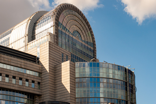 As seen from the Leopold Park in Brussels, the glass facade of the Paul Henri Spaak building of the European Parliament in Brussels. The Parliament's committee meetings are held primarily here in Brussels. The Paul-Henri Spaak building of the European Parliament was named after former President Paul-Henri Spaak. It houses the plenary sessions as well as a press centre and offices for the Parliament's president. It has a striking cylinder-shaped glass dome.