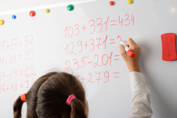Female learner counting big numbers on the whiteboard