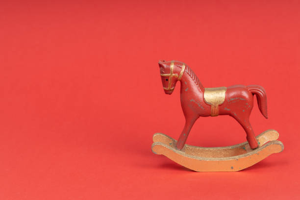 istock Red vintage rocking horse on red background 1288301866
