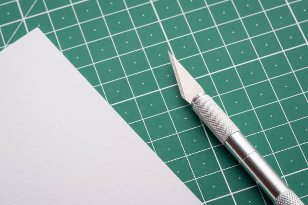 istock Sharp scalpel near cut paper on cutting mat 1288302025