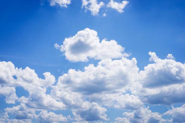 Fluffy clouds against sunlight in sky stock photo