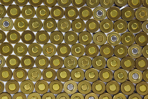 For the entire frame, the rows of cartridge cases are close-up. The cartridges are not marked