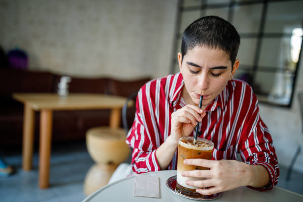 istock Young Bald Woman Drink Iced Pumpkin Spice Latte 1288305162