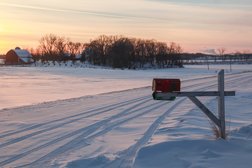Mailbox in rural Minnesota, USA. Christmas time sunset on a Winters day. Farm life.