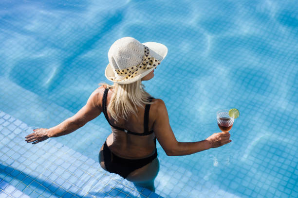 istock Woman in pool holding drink 1288307189