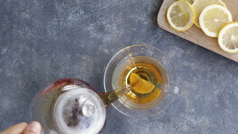 Preparing a cup of tea with lemon slice