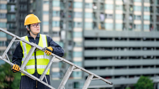 istock Maintenance worker man carrying aluminium ladder 1288307614