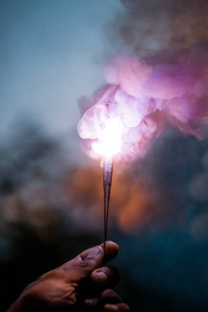 Person Holding colorful Lighted Sparkler during Nighttime