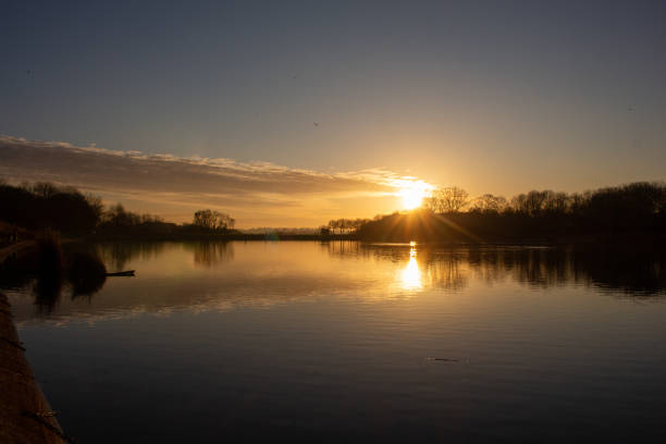 istock Sunset over a lake intense orange and dark colors at dusk 1288313013
