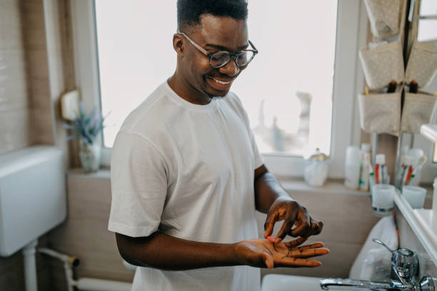 istock Young man takes vitamin in the morning 1288313095