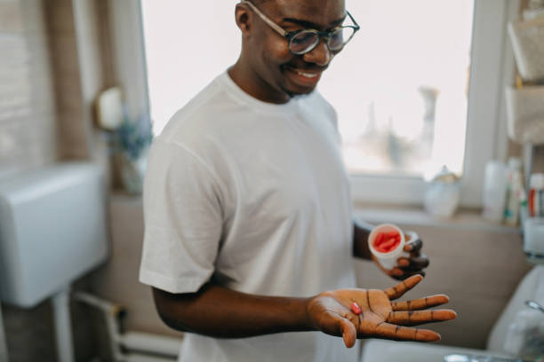 Young man takes vitamin in the morning