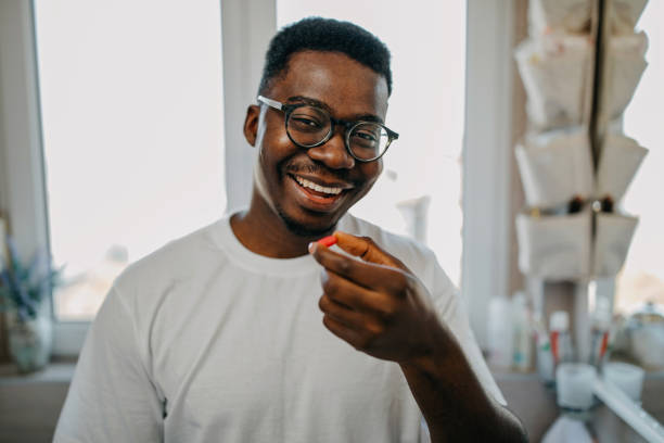 istock Young man takes vitamin in the morning 1288313111