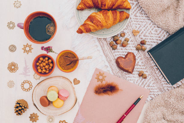 Bright boho cozy still life with coffee and macaroons directly from above