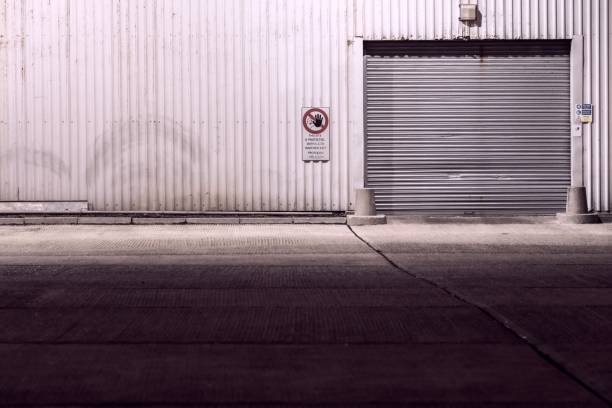 istock Shuttered entrance to an industrial warehouse 1288320129