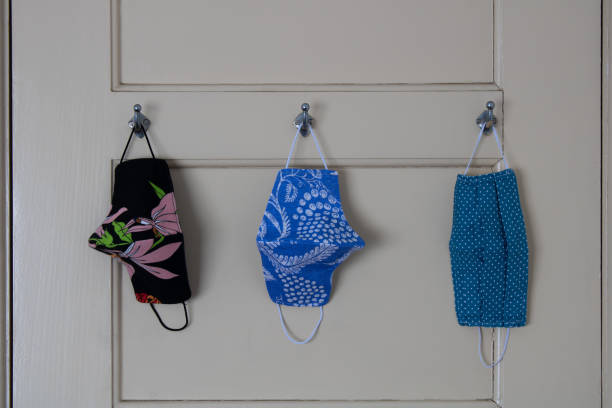 istock Three face masks hanging on door hooks 1288324145