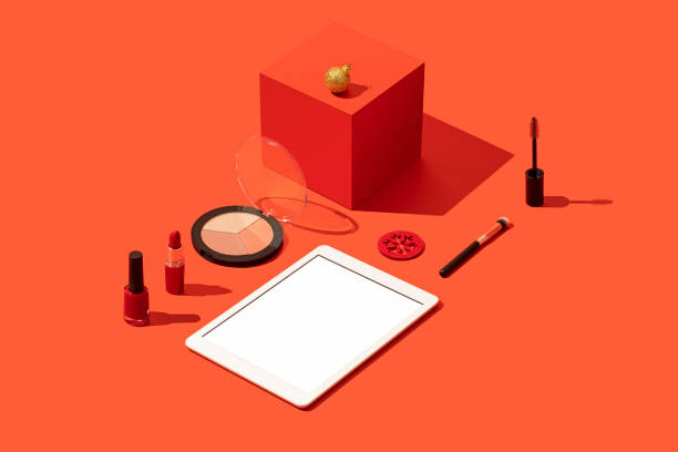 istock Digital tablet mockup, template with makeup, cosmetics flat lay on red background 1288324466