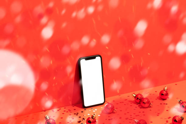 istock Smart phone mockup, template on red Christmas background under confetti rain 1288325226