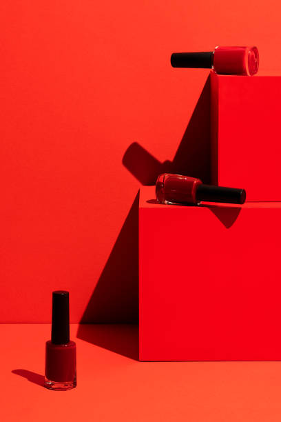 istock Red nail polish on red cubic background 1288325345